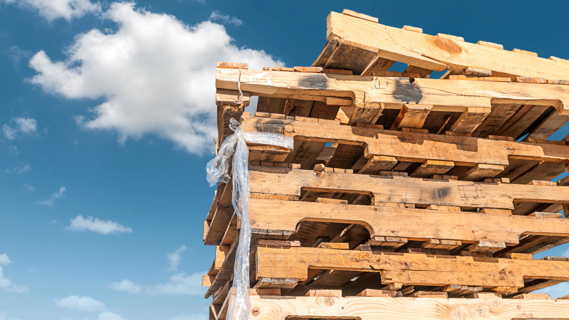 Stack of wood pallets in a grassy field